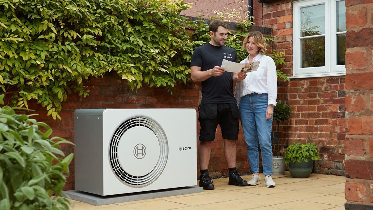 Heat pump installer explaining the system to a homeowner